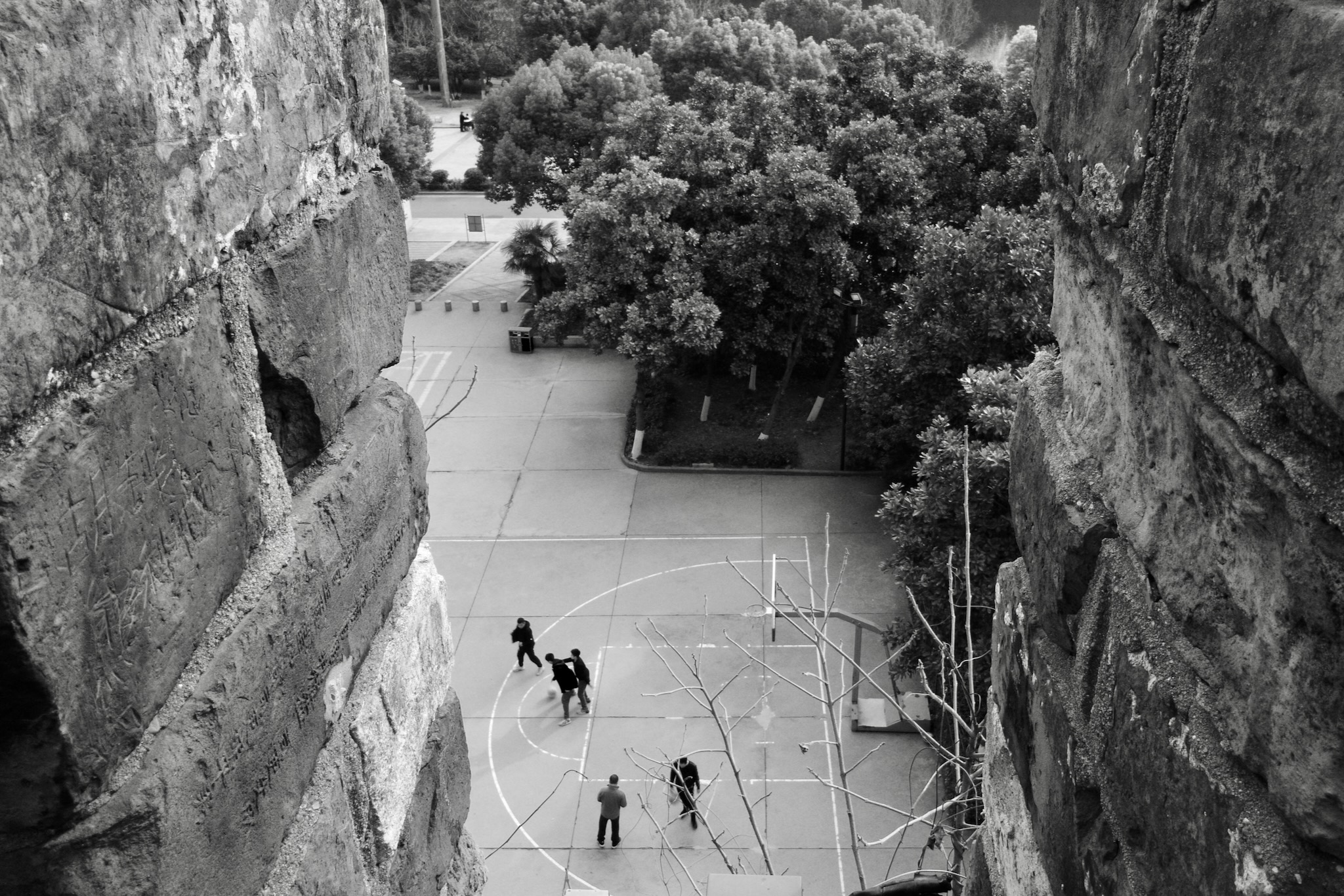 Young people playing basketball by Nanjing City Wall