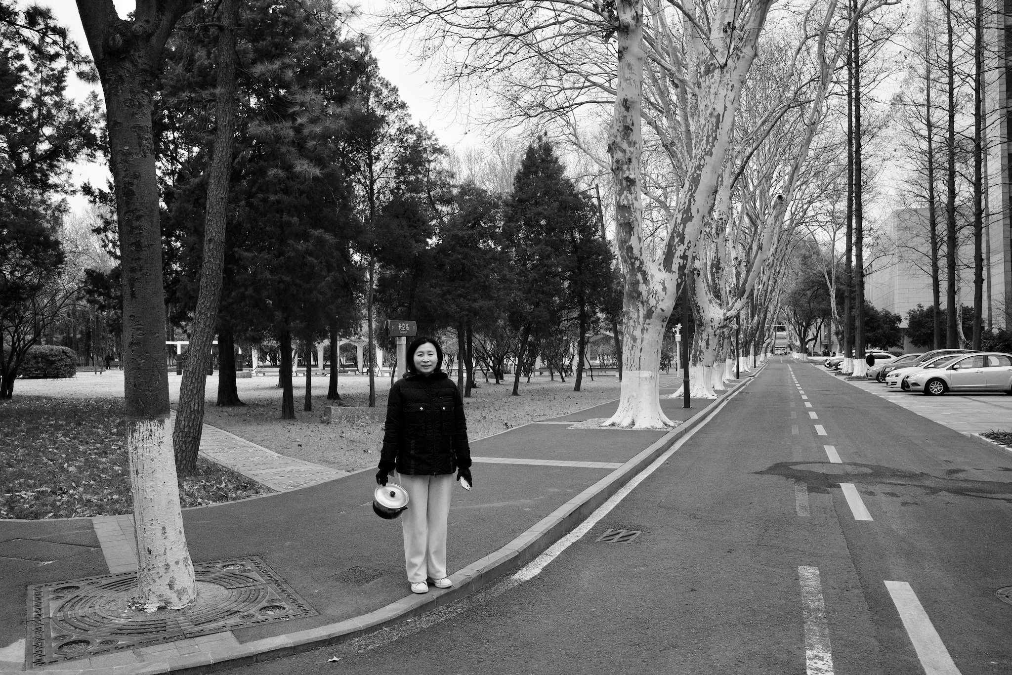Emma walking onto the campus with a pot in her hand